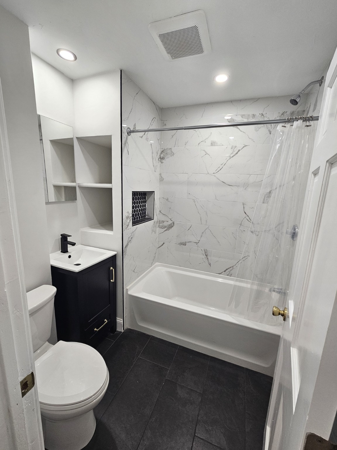 Renovated bathroom with marble-look tile surround at 30 Thorne Street, Apartment 1